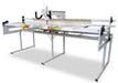 Janome Quilt Maker 15 long arm quilting machine mounted on 8-foot Lite Frame quilting a full-size quilt