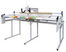 Rear view of Janome Quilt Maker 15 long arm quilting machine showing control screen, handlebars, and free-motion quilting area