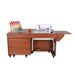 Front view of Kangaroo & Joey Electric Sewing Cabinet with machine platform lowered and teak finish