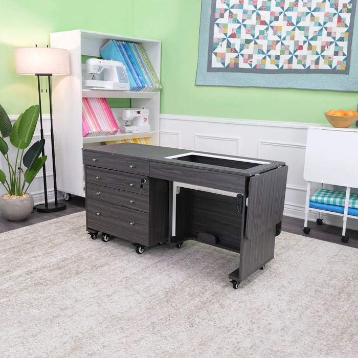 Gray Kangaroo & Joey Dual Rail Electric Sewing Cabinet in sewing room setup with storage drawers and machine lift platform