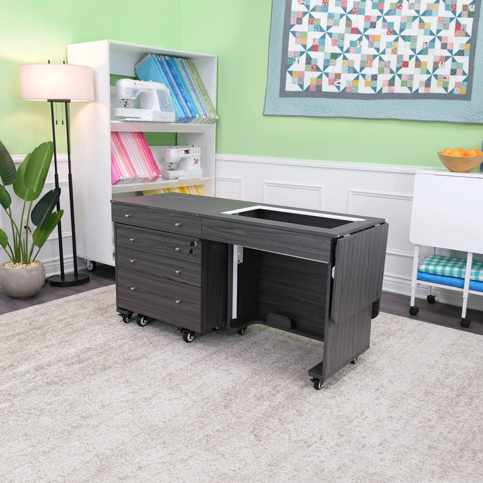 Compact folded Kangaroo & Joey Sewing Cabinet in gray with Joey storage caddy tucked underneath, displayed in modern sewing and crafting room.