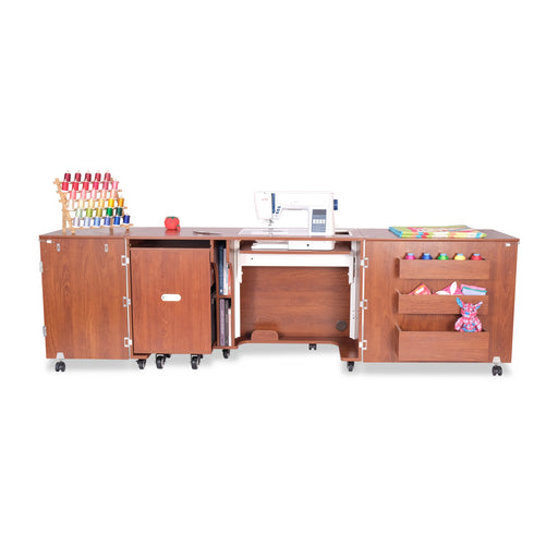 Front view of the Kangaroo Aussie Sewing Cabinet in Teak K8605 extended, showing storage shelves, sewing machine platform, and fold-out workspace.