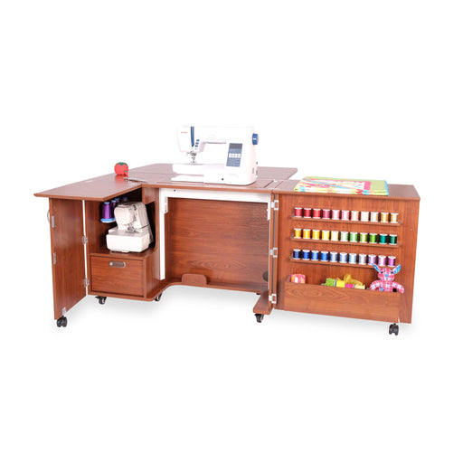 Kangaroo Wallaby Teak Sewing Cabinet K8405 displayed with sewing machine table extended and serger platform folded inside cabinet.