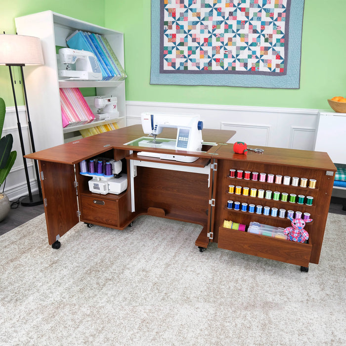 Kangaroo Wallaby Teak Sewing Cabinet K8405 displayed in sewing room setup with sewing machine, quilting leaf, and colorful thread storage.