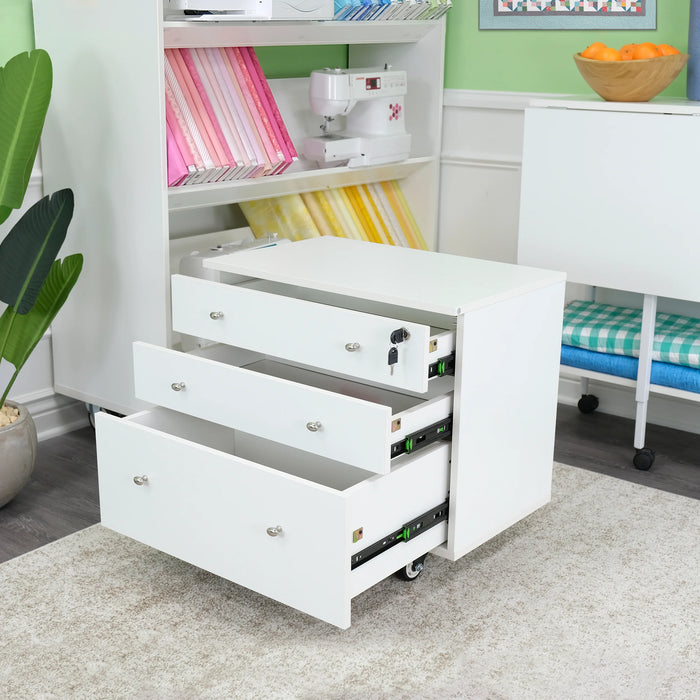 Kangaroo Joey Storage Cabinet in Ash White K7811 shown with open drawers inside a sewing room, highlighting spacious soft-close storage.