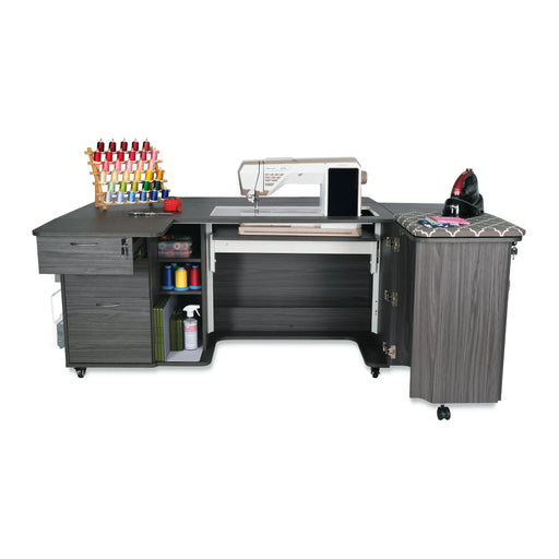Kangaroo Sydney Hydraulic XL Sewing Cabinet in gray with sewing machine installed, thread storage, and built-in pressing station for quilting and embroidery.