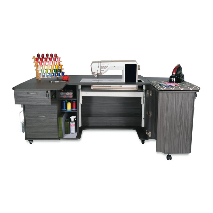 Kangaroo Sydney Hydraulic XL Sewing Cabinet in gray with sewing machine installed, thread storage, and built-in pressing station for quilting and embroidery.