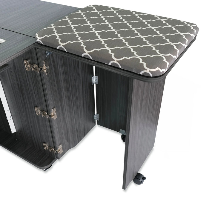 Side leaf extension and built-in cushioned pressing mat on the Kangaroo Sydney Hydraulic XL Sewing Cabinet in gray woodgrain finish.