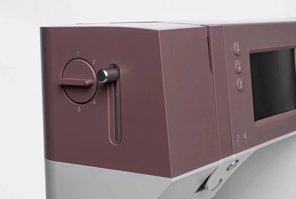 Close-up of a kitchen appliance with control knobs and display on a white background