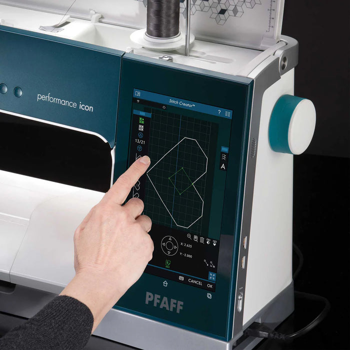 PFAFF sewing machine with digital display and hand interacting with it