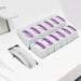 White pill organizer with purple labels on a white background