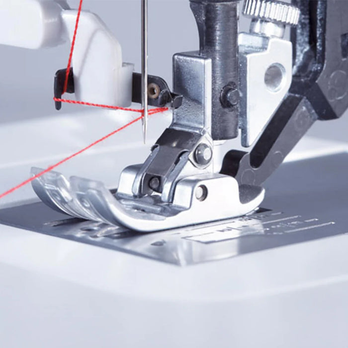 Close-up of a sewing machine needle and foot with red thread on a light gray background