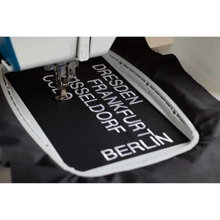 Close-up of Pfaff Creative Expect 350 embroidery hoop stitching detailed lettering design