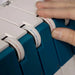 Close-up of a person using a blue and white measuring device.