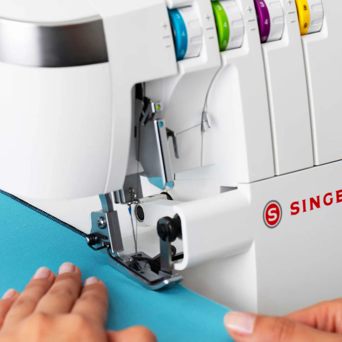 SINGER SE017 Elite overlock machine finishing fabric edge with professional serger stitch and color-coded tension dials