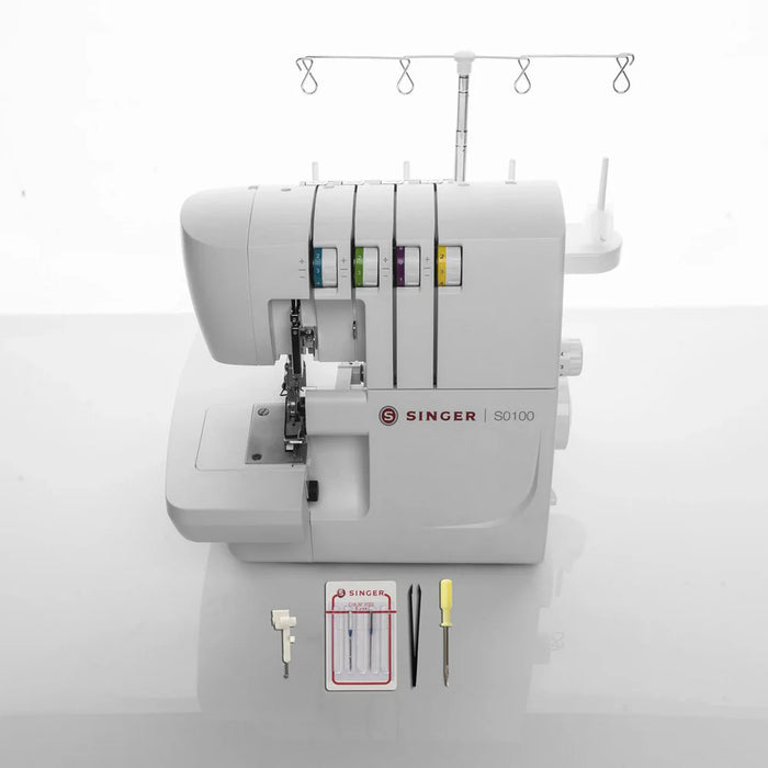 SINGER S0100 serger sewing machine front view with included accessories such as needles, screwdriver, and threading tools