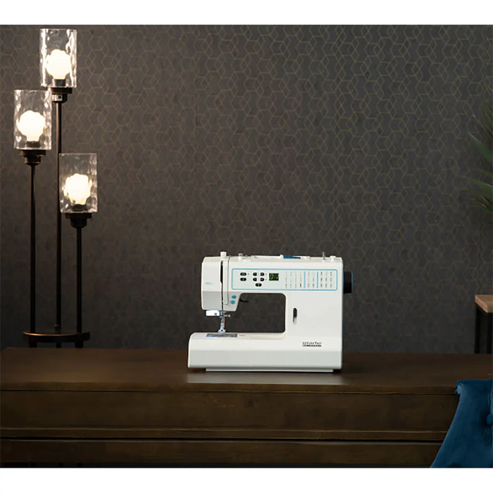 White sewing machine on a wooden table with a dark patterned wall in the background