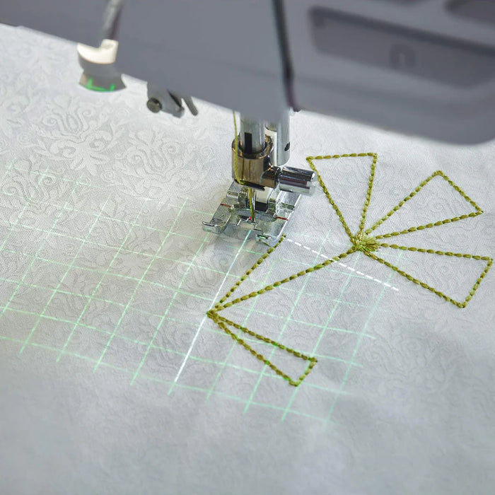 Sewing projection grid and stitch placement guide displayed on fabric while quilting with the EPIC QUILT 97 sewing machine