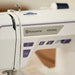 Husqvarna Viking Designer Quartz 29 sewing machine control buttons and Husqvarna Viking logo close-up