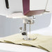 Close-up of Husqvarna Viking Designer Topaz 65 presser foot sewing lightweight fabric with precision stitching