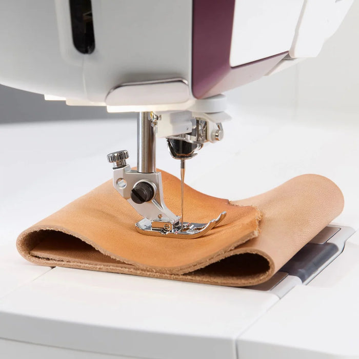 Detailed view of Husqvarna Viking Designer Topaz 65 needle area and integrated sewing controls