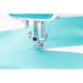 Close-up of a sewing machine needle on a light blue fabric background