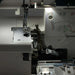 Close-up of a sewing machine with needle and thread