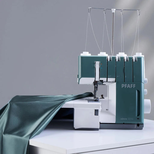 PFAFF sewing machine on a gray background with green fabric