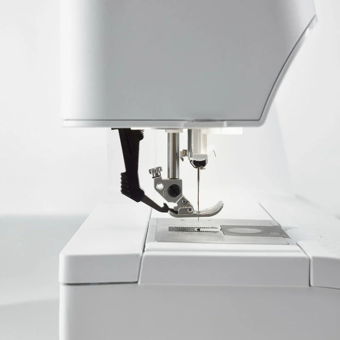 Close-up of a sewing machine on a white background